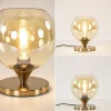 kleine_tafellamp_goud_met_3.webp Online Straluma Kleine tafellamp goud met amber kleurig glas