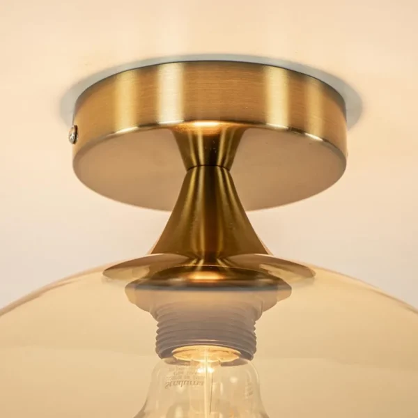 plafondlamp_goud_met_ambe_2.webp Clearance Straluma Plafondlamp goud met amber glazen bol 30 cm